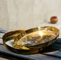 Handmade brass plates manufactured in India featuring serving plates, decorative plates, pooja thalis, engraved brass plates, and custom brass plate designs for wholesale buyers and global importers.