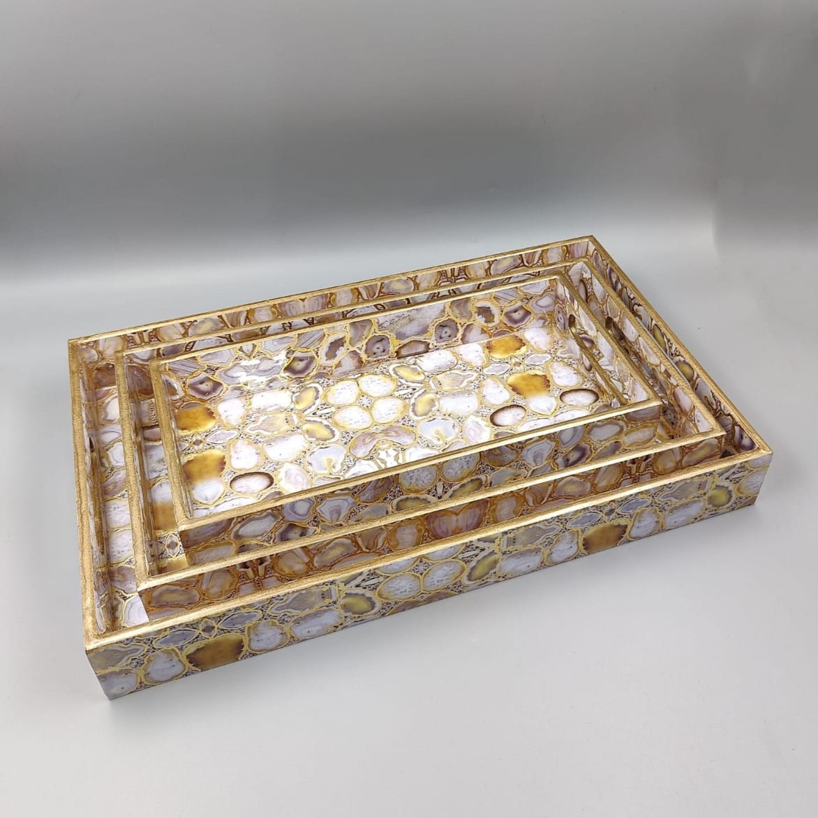Decorative gold mirrored serving tray set with geometric pattern for luxury home décor.