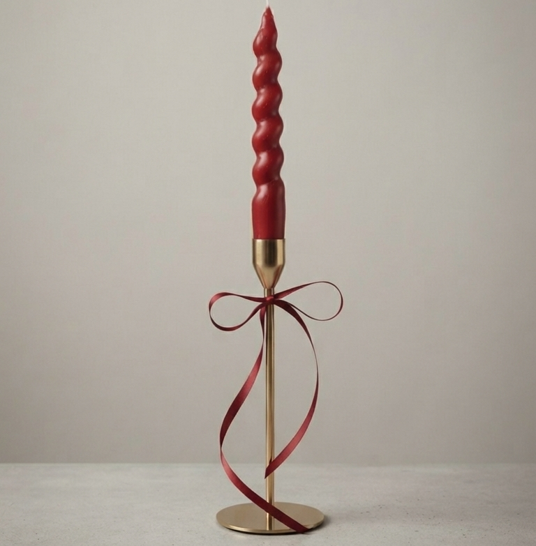 Handcrafted burgundy spiral taper candle with elegant gold metal stand for home décor, weddings, and wholesale export from India.