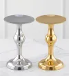 Decorative metal pedestal candle holder in polished gold and silver finish