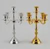 Five arm metal candelabra in polished gold and silver finish