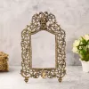 Ornate antique brass photo frame with mythological face design.