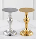 Decorative metal pedestal candle holder in polished gold and silver finish