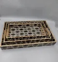Handcrafted decorative wooden serving tray set with black and gold geometric pattern.