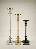 Tall decorative metal pillar candle holder in silver, gold, and matte black finishes
